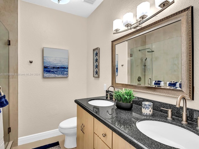 bathroom with vanity, an enclosed shower, and toilet