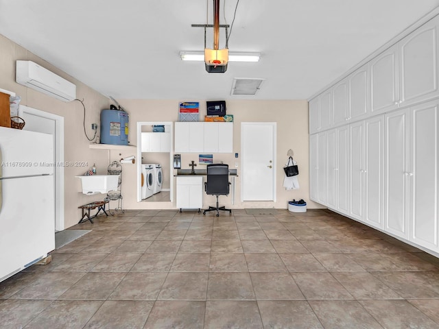 garage with sink, a wall mounted air conditioner, separate washer and dryer, electric water heater, and white refrigerator