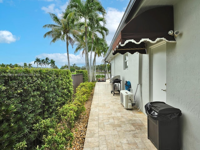 view of side of home with a patio area