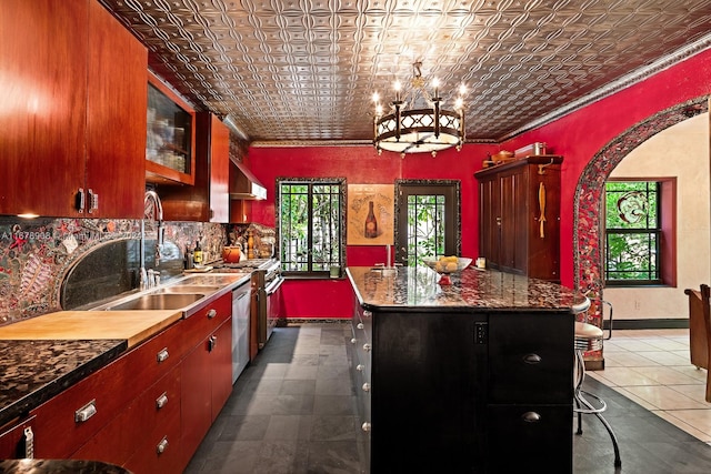 kitchen with a healthy amount of sunlight, ventilation hood, dishwasher, and a kitchen island