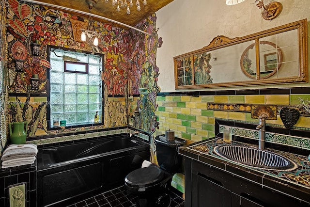 bathroom with vanity, toilet, tile patterned floors, and a bath