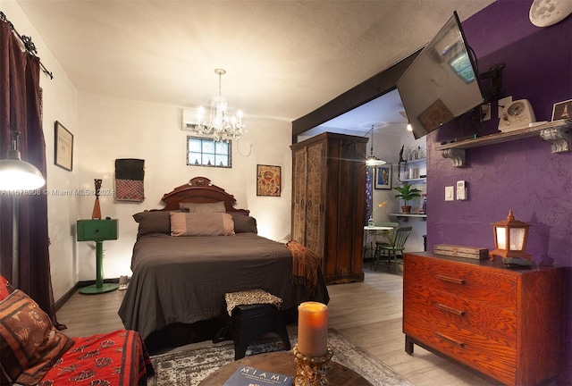 bedroom featuring light hardwood / wood-style floors and a notable chandelier