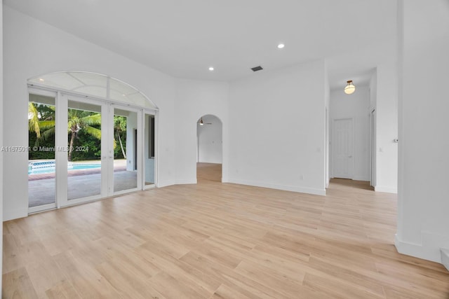 unfurnished room featuring french doors and light hardwood / wood-style floors