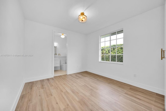 spare room featuring light hardwood / wood-style floors