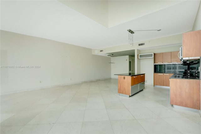 kitchen with light tile patterned floors, tasteful backsplash, a center island, and hanging light fixtures