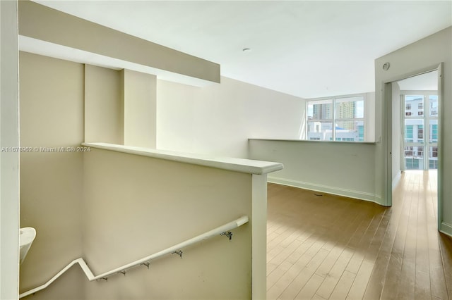 hallway with hardwood / wood-style floors