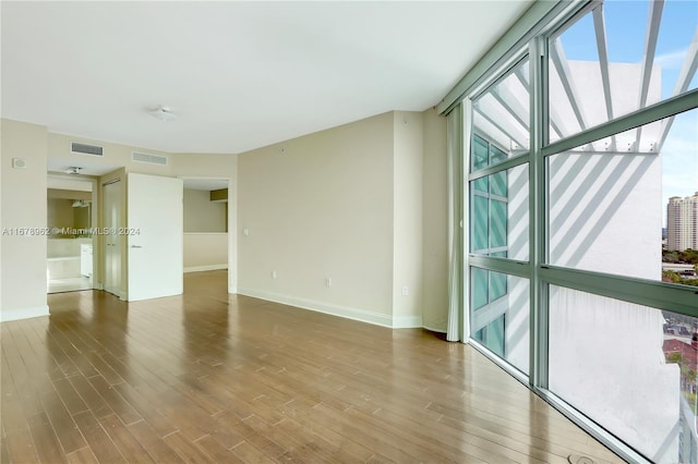 unfurnished room with hardwood / wood-style floors