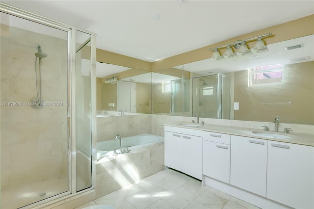 bathroom with vanity and separate shower and tub