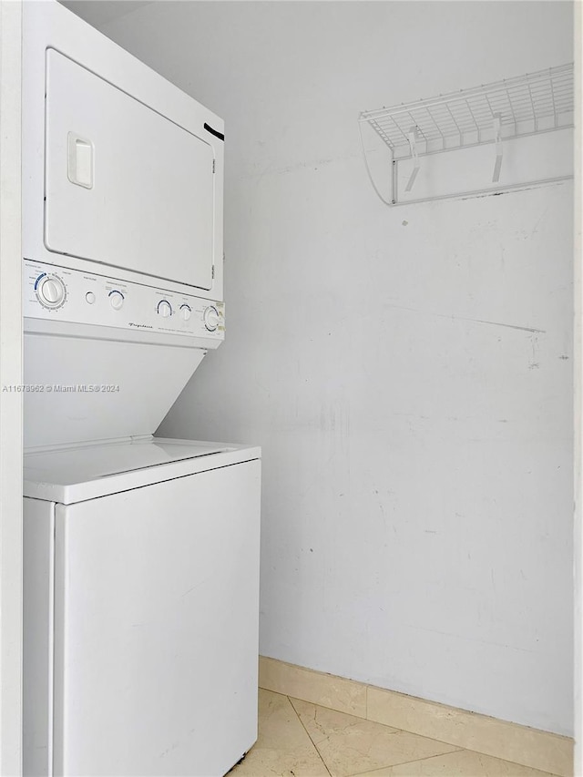 laundry area with stacked washer / drying machine