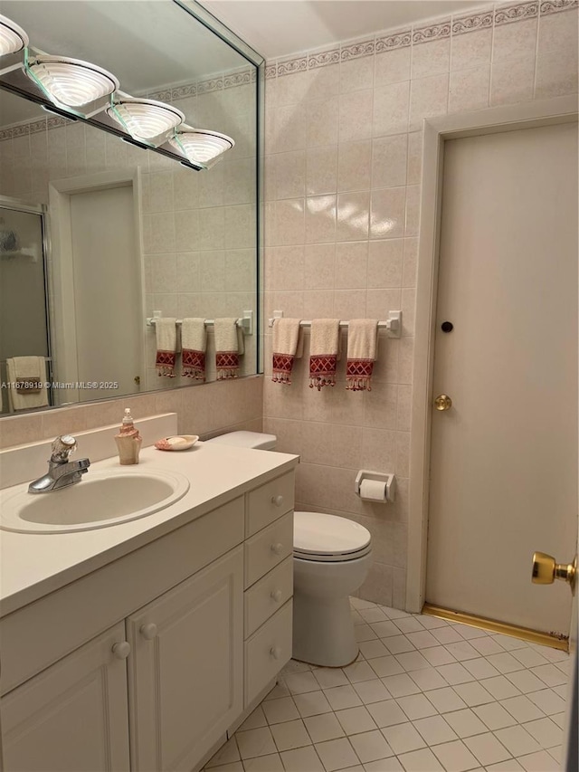 3440 NE 170th St, North Miami Beach, FL 33160 - bathroom with a stall shower, tile walls, toilet, tile patterned flooring, and vanity