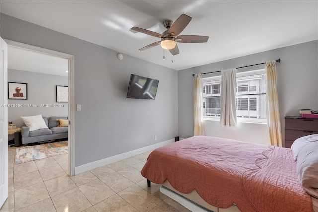 tiled bedroom featuring ceiling fan