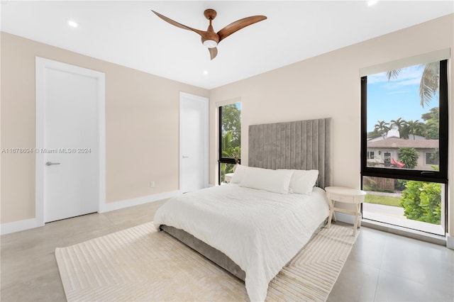 bedroom featuring multiple windows and ceiling fan