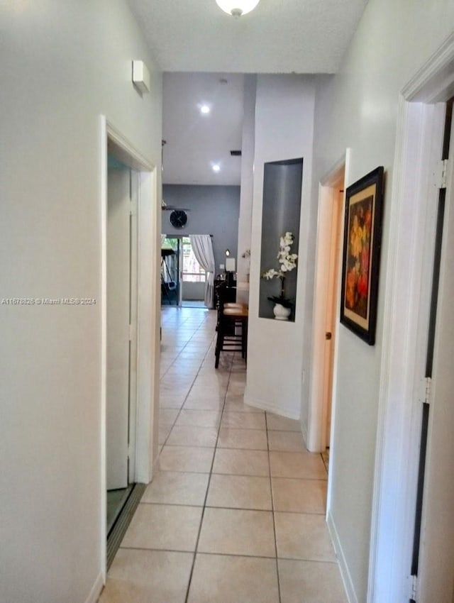 corridor with light tile patterned floors