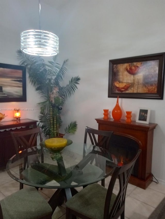 tiled dining space featuring a chandelier