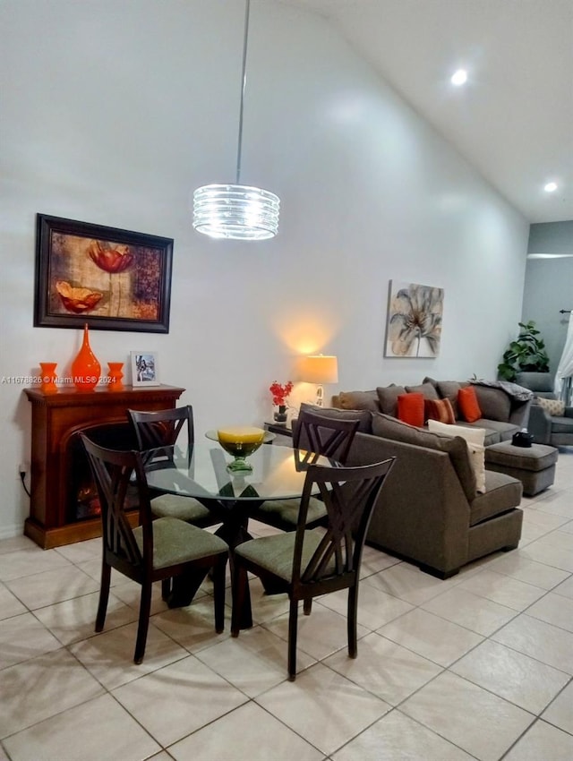 tiled dining area with high vaulted ceiling