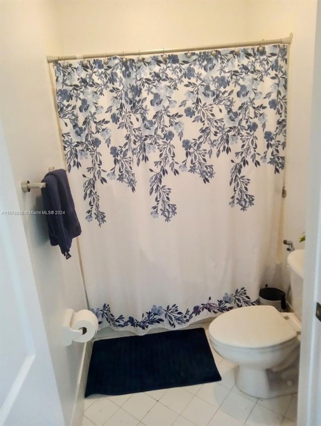 bathroom with toilet and tile patterned floors