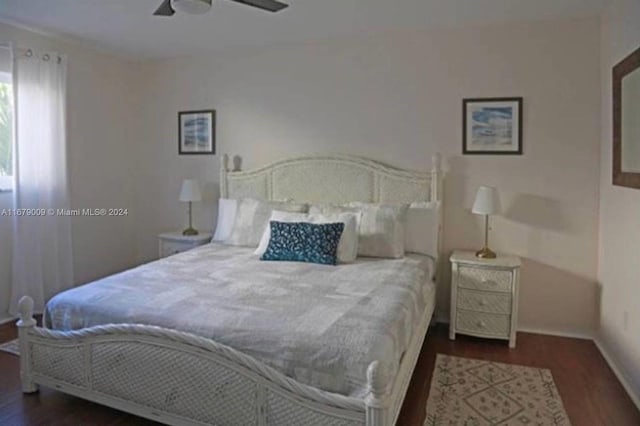 bedroom with ceiling fan and dark hardwood / wood-style flooring