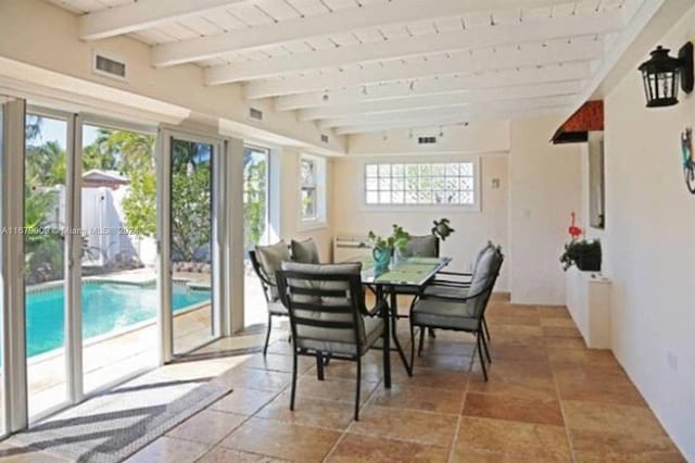 dining space with beam ceiling and wooden ceiling