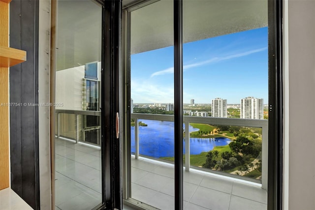 interior space featuring tile patterned floors, a wealth of natural light, and a water view