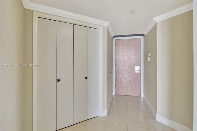 hall with light tile patterned floors and ornamental molding