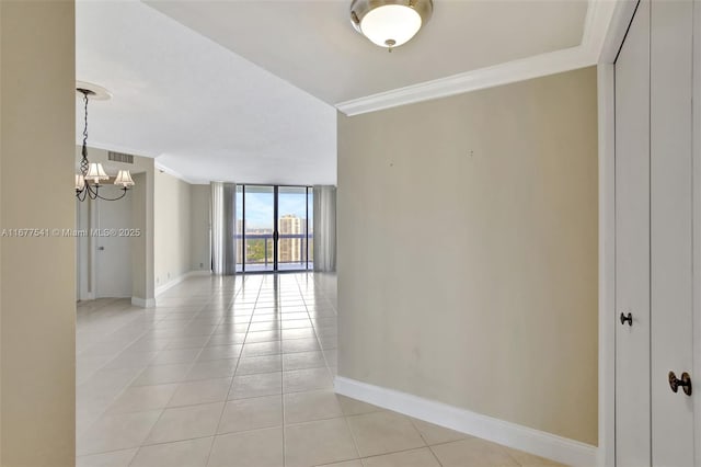 20185 E Country Club Dr Unit 2209, Aventura, FL 33180 - unfurnished room with a chandelier, light tile patterned floors, a wall of windows, crown molding, and baseboards