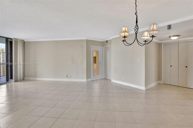 tiled empty room featuring an inviting chandelier, a textured ceiling, and ornamental molding