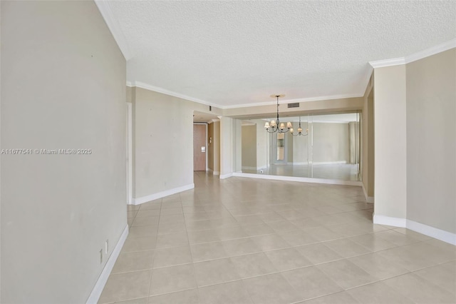 unfurnished room with a chandelier, light tile patterned floors, a textured ceiling, and crown molding