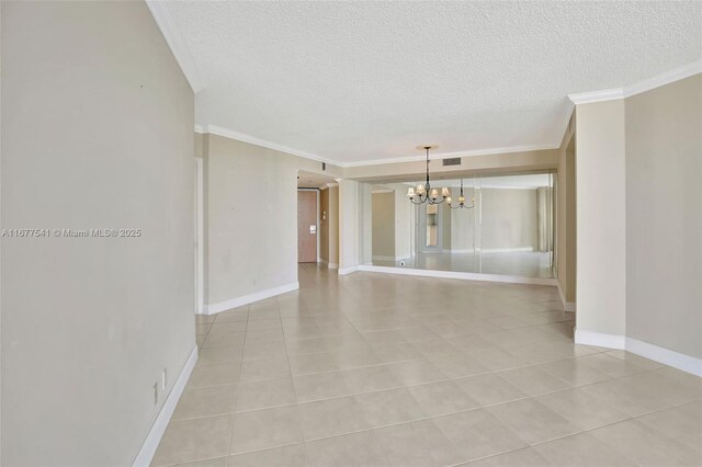 20185 E Country Club Dr Unit 2209, Aventura, FL 33180 - unfurnished room with a chandelier, a textured ceiling, light tile patterned floors, crown molding, and baseboards