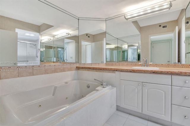 bathroom with tile patterned floors, vanity, and separate shower and tub