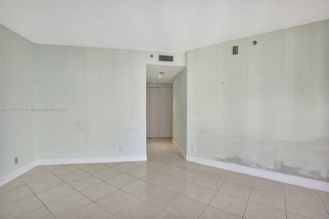 20185 E Country Club Dr Unit 2209, Aventura, FL 33180 - unfurnished room featuring light tile patterned floors, baseboards, and a textured ceiling