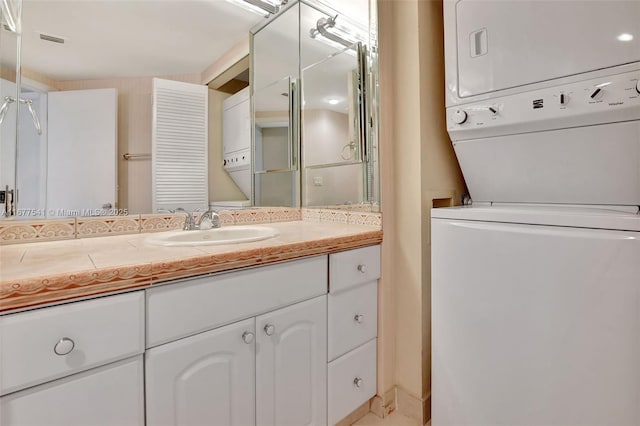 bathroom featuring vanity and stacked washing maching and dryer