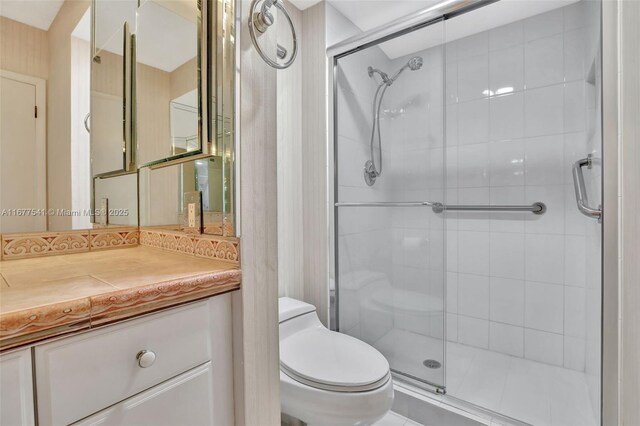 bathroom featuring vanity, toilet, and walk in shower