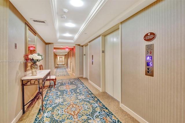 hallway featuring light carpet and crown molding