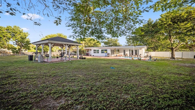 view of yard with a gazebo, a fenced in pool, and a patio area