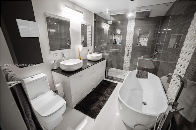 full bathroom featuring tile patterned floors, vanity, independent shower and bath, and toilet