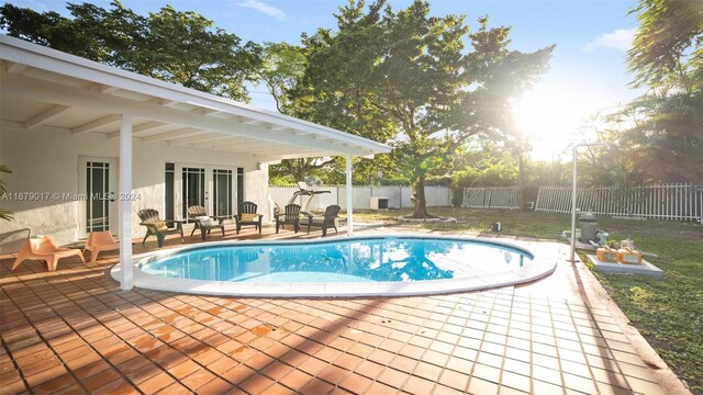 13550 SW 99th Pl, Miami, FL 33176 - view of pool featuring a patio area and a fenced backyard
