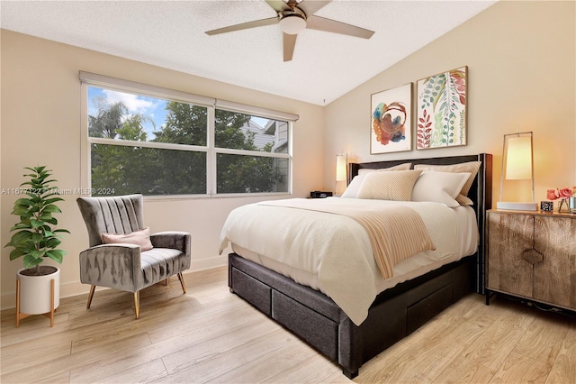 bedroom featuring ceiling fan, lofted ceiling, and light wood-type flooring