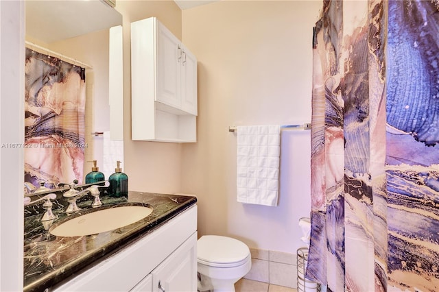 bathroom featuring tile patterned flooring, vanity, and toilet