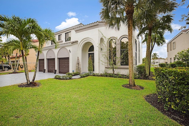 mediterranean / spanish home featuring a front lawn