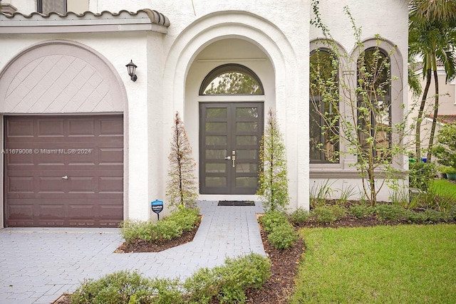 view of exterior entry with a garage