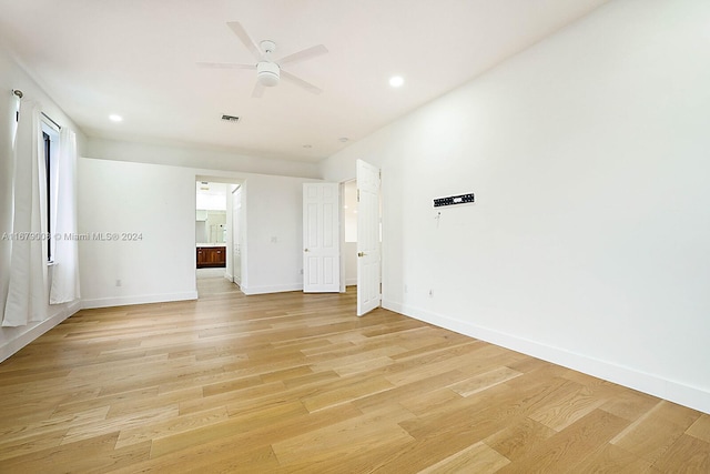 empty room with light hardwood / wood-style floors and ceiling fan