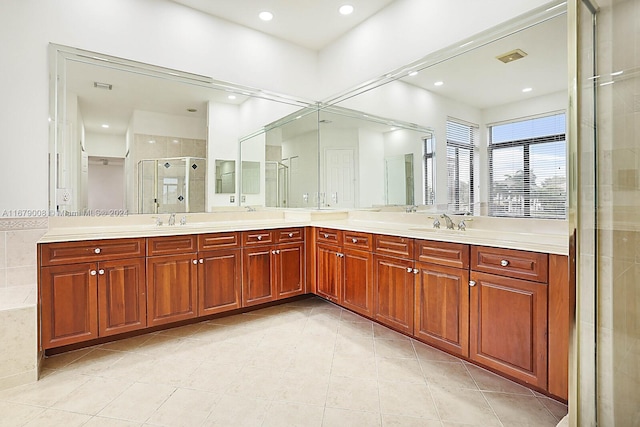 bathroom featuring vanity, a shower with shower door, and tile patterned flooring