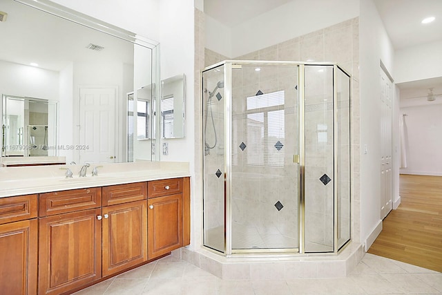 bathroom featuring vanity, walk in shower, and hardwood / wood-style flooring