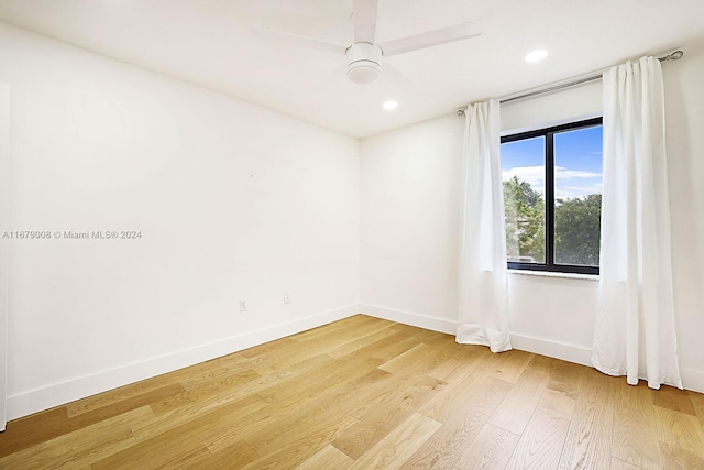 empty room featuring light hardwood / wood-style flooring and ceiling fan