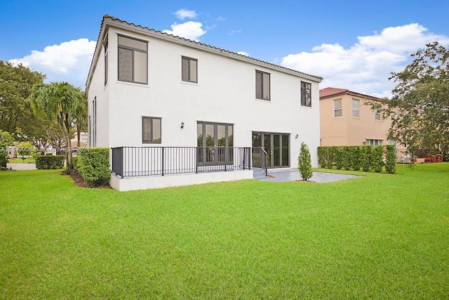 rear view of house featuring a yard and a patio area