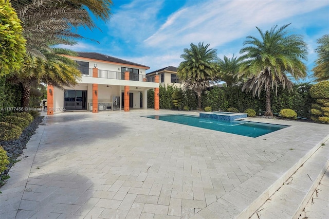 view of swimming pool with a patio area and an in ground hot tub