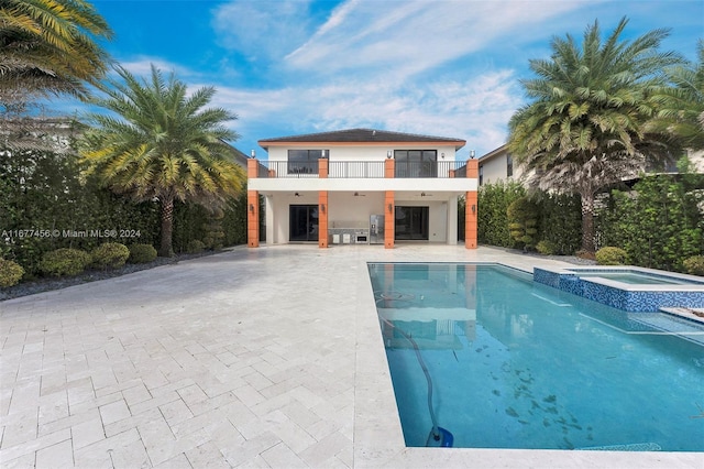 view of pool with an in ground hot tub and a patio