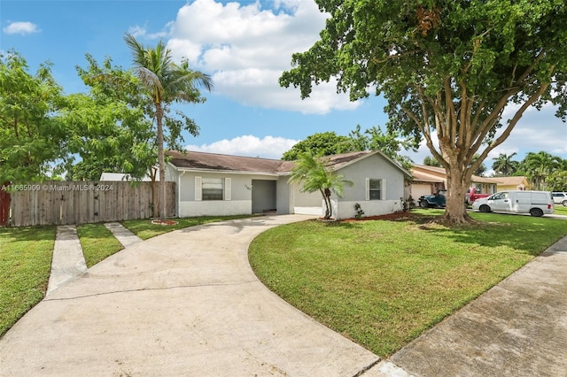 ranch-style house with a front yard and a garage