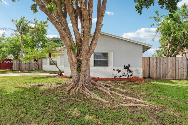 view of side of home featuring a lawn