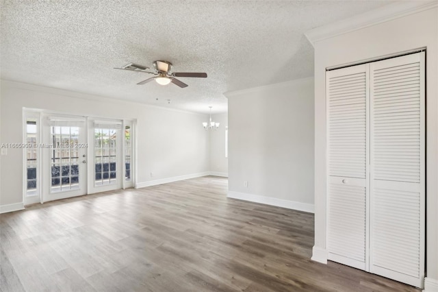 unfurnished living room with a textured ceiling, ceiling fan with notable chandelier, and hardwood / wood-style floors